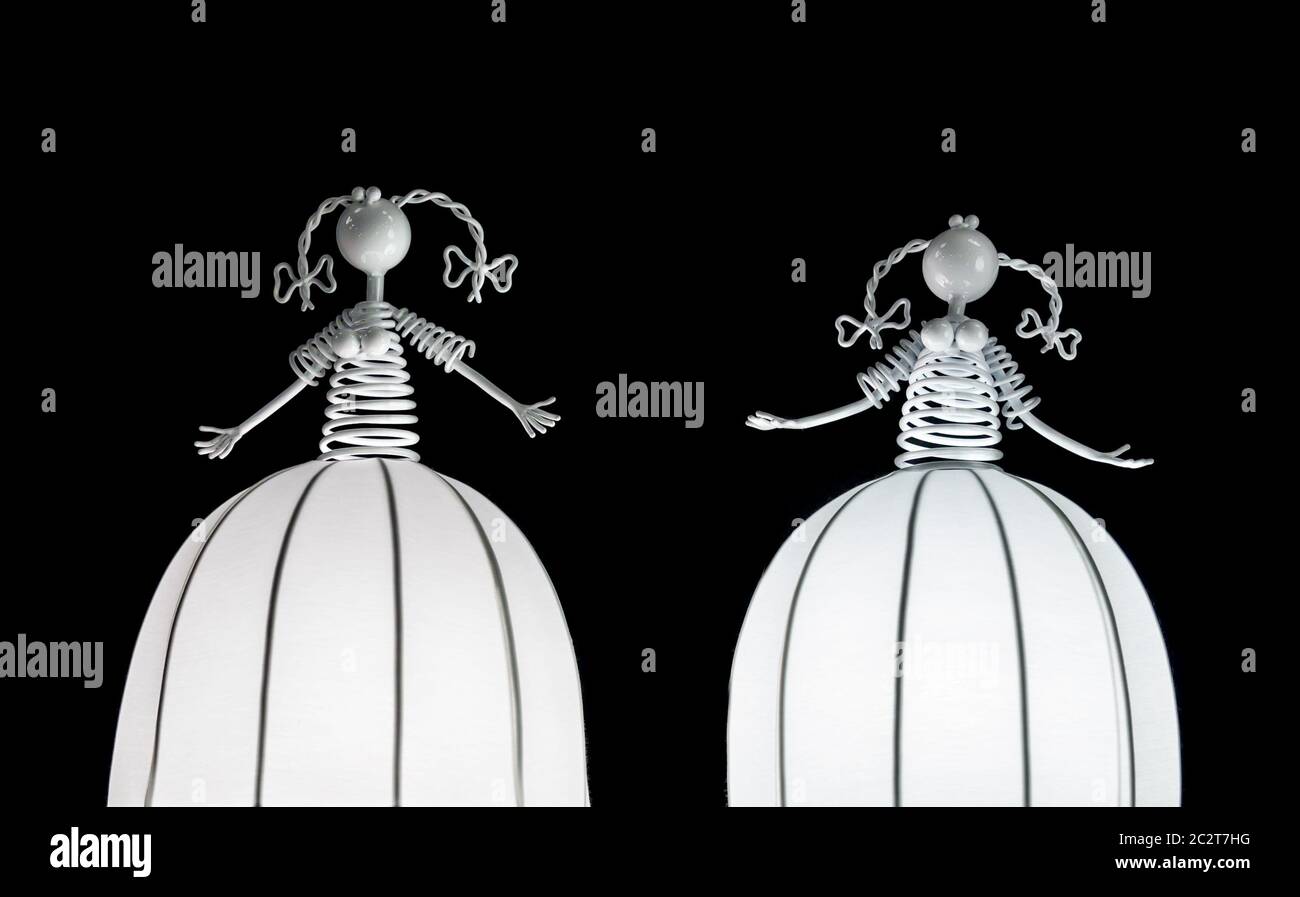 Cute White Decorative Lanterns With Human Figures On The Tops Stand In The Darkness Stock Photo Alamy