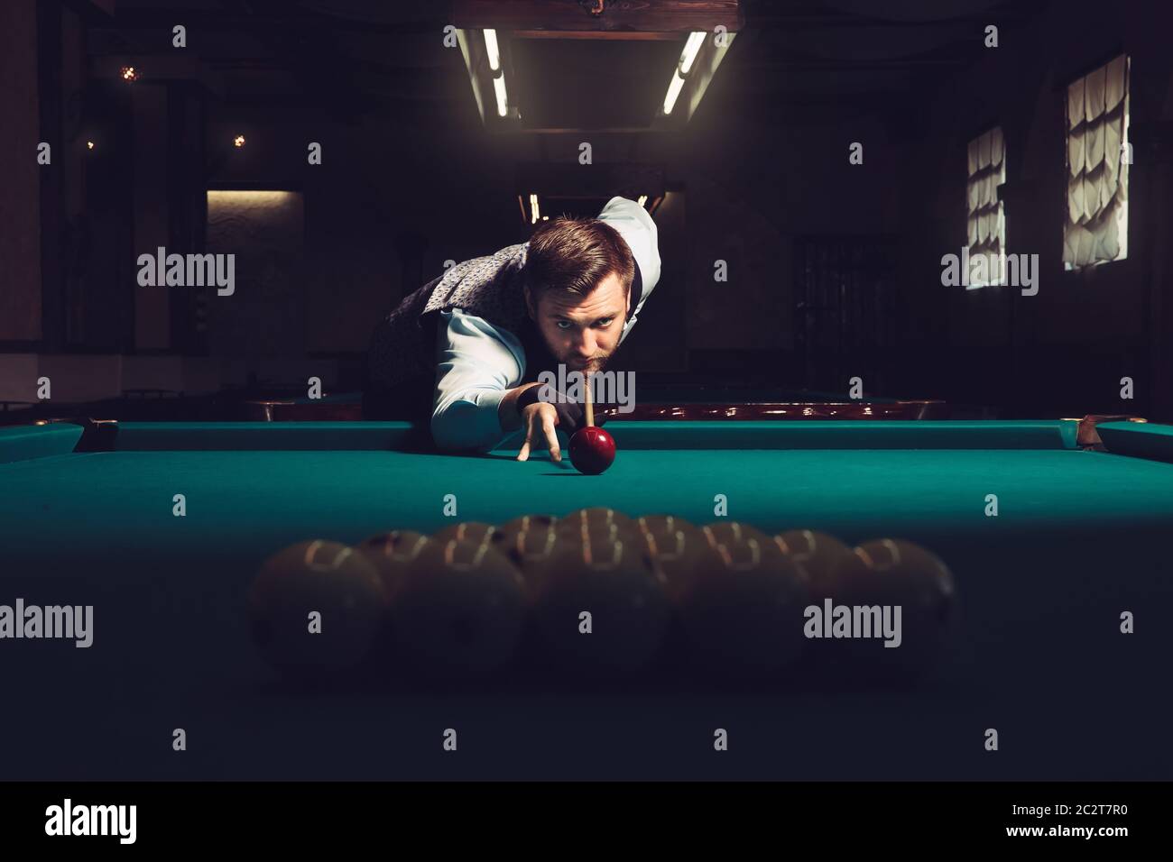 Young man preparing to shoot balls in triangle Stock Photo