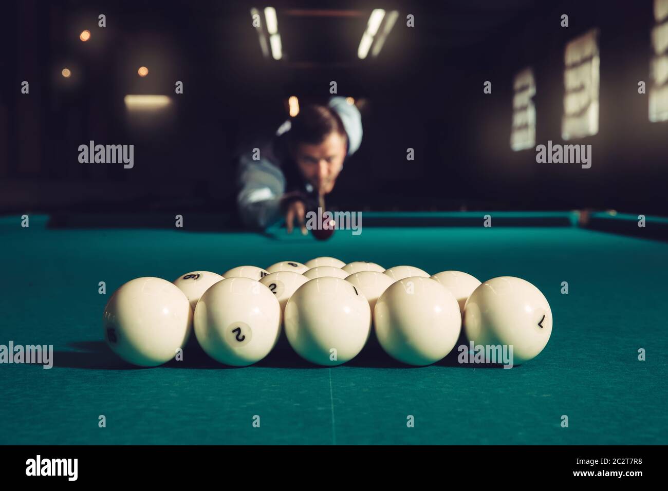 Young man preparing to shoot balls in triangle Stock Photo