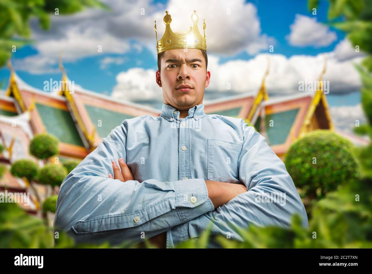 Powerful man wearing crown on the head with crossed hands as a king Stock Photo