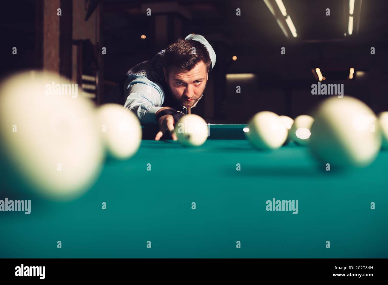 Young man preparing to shoot balls in triangle Stock Photo