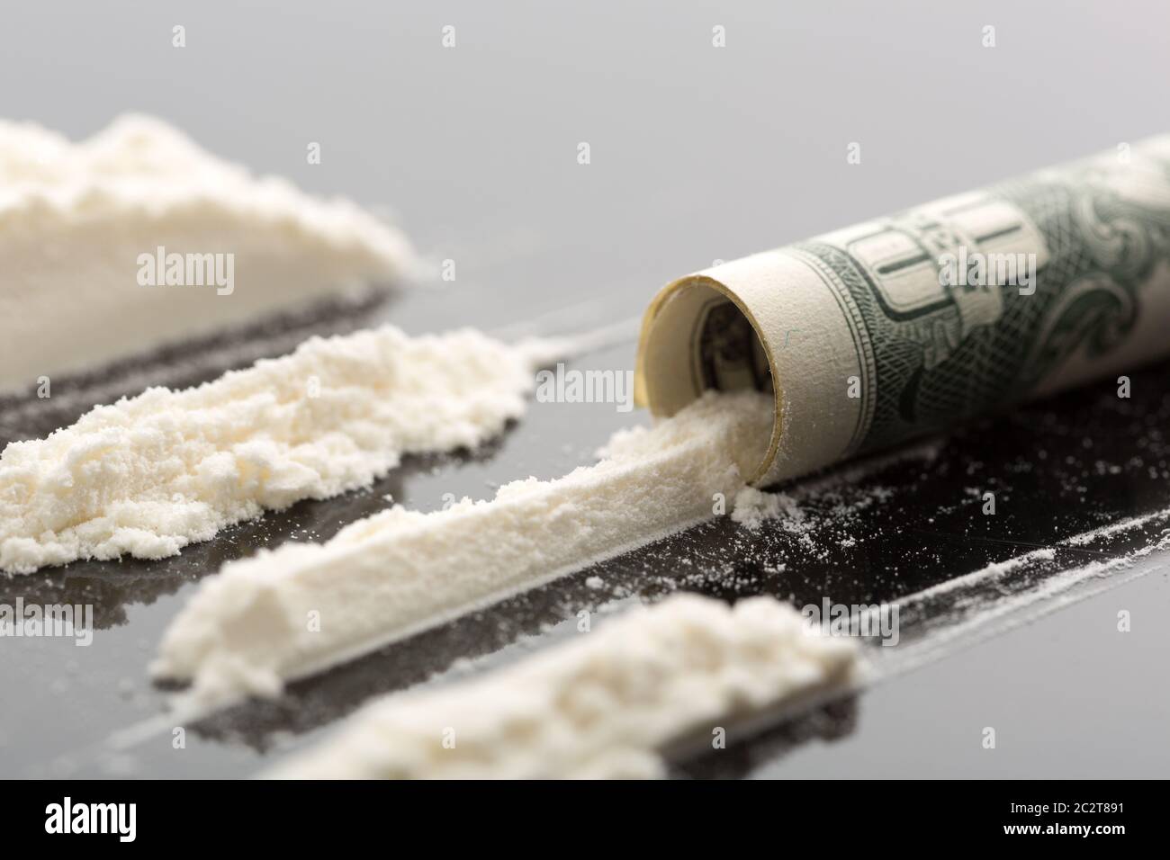 Cocaine lines and 10 dollars note on grey background Stock Photo