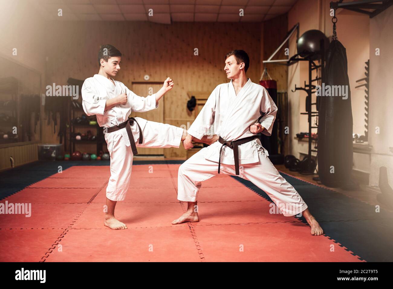 Martial arts masters in white kimono and black belts, selfdefence