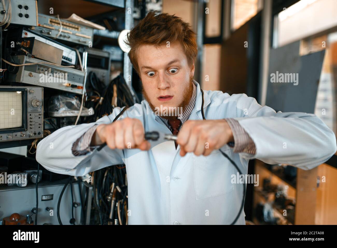 Crazy engineer connects wires under tension in laboratory. Electrical