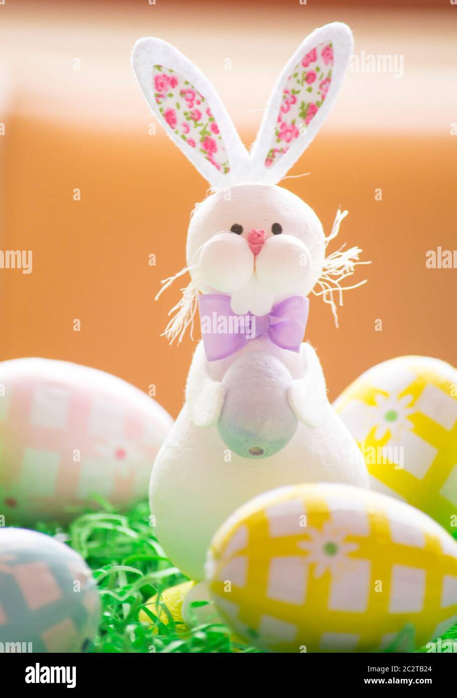 Eastern bunny with eggs and a green background Stock Photo - Alamy