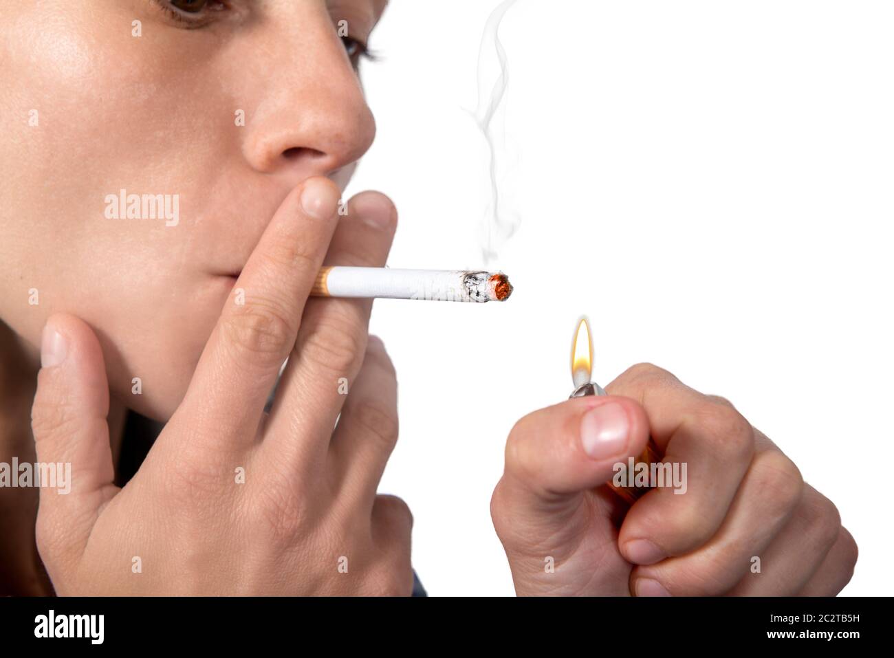Young woman lighting cigarette isolated on the white background Stock