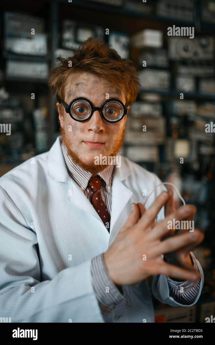 Crazy male scientist in glasses working in laboratory. Electrical