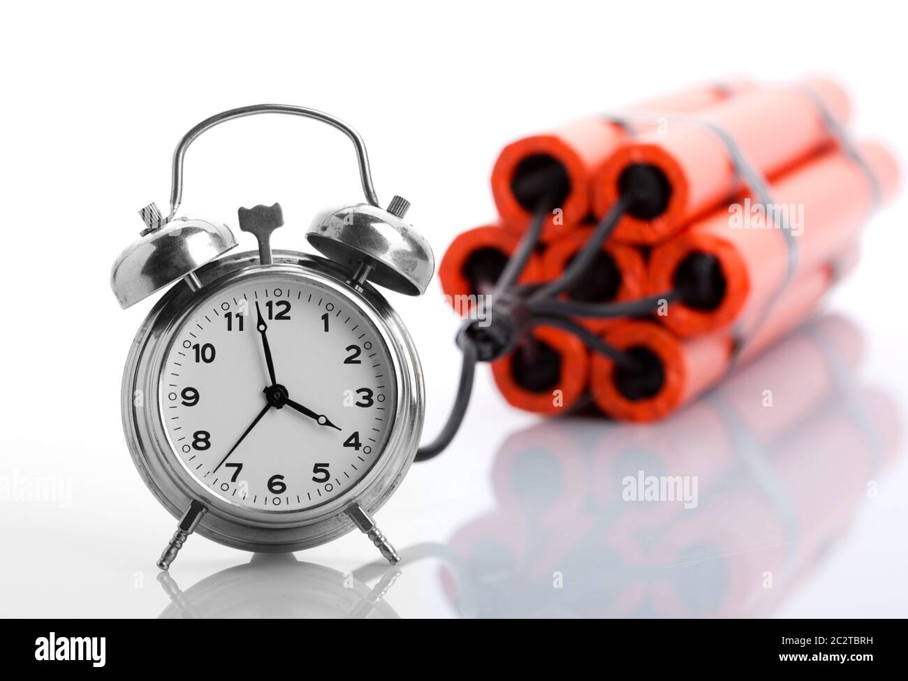 Alarm clock and dynamite on white Stock Photo Alamy