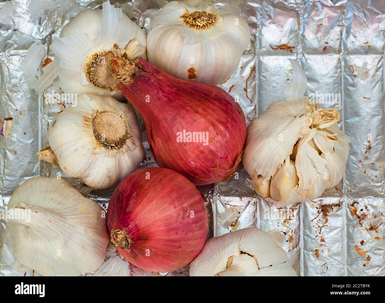 garlic and onion heads with foil background Stock Photo Alamy