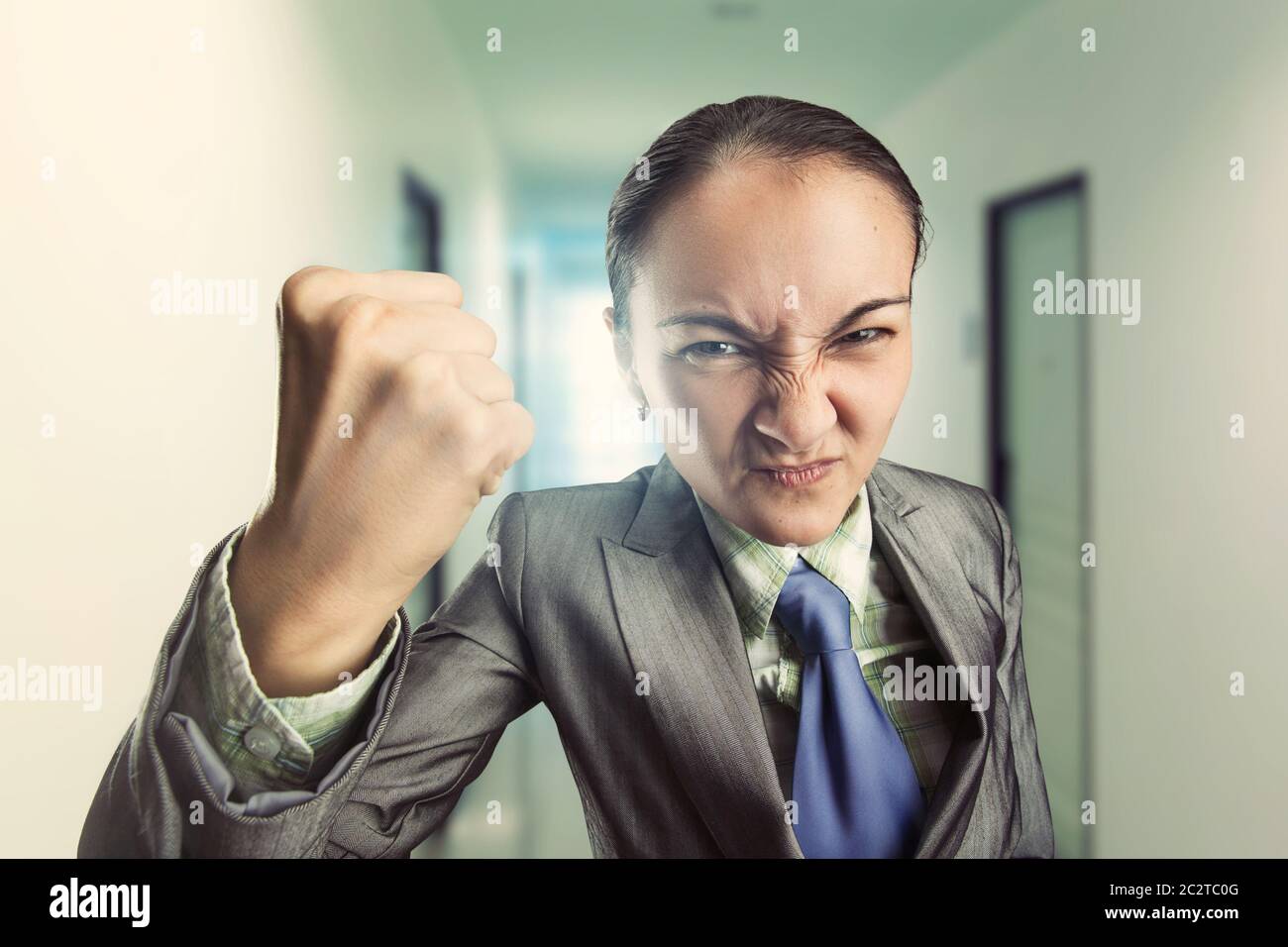 Angry irritated woman clenching her fist in the office Stock Photo Alamy