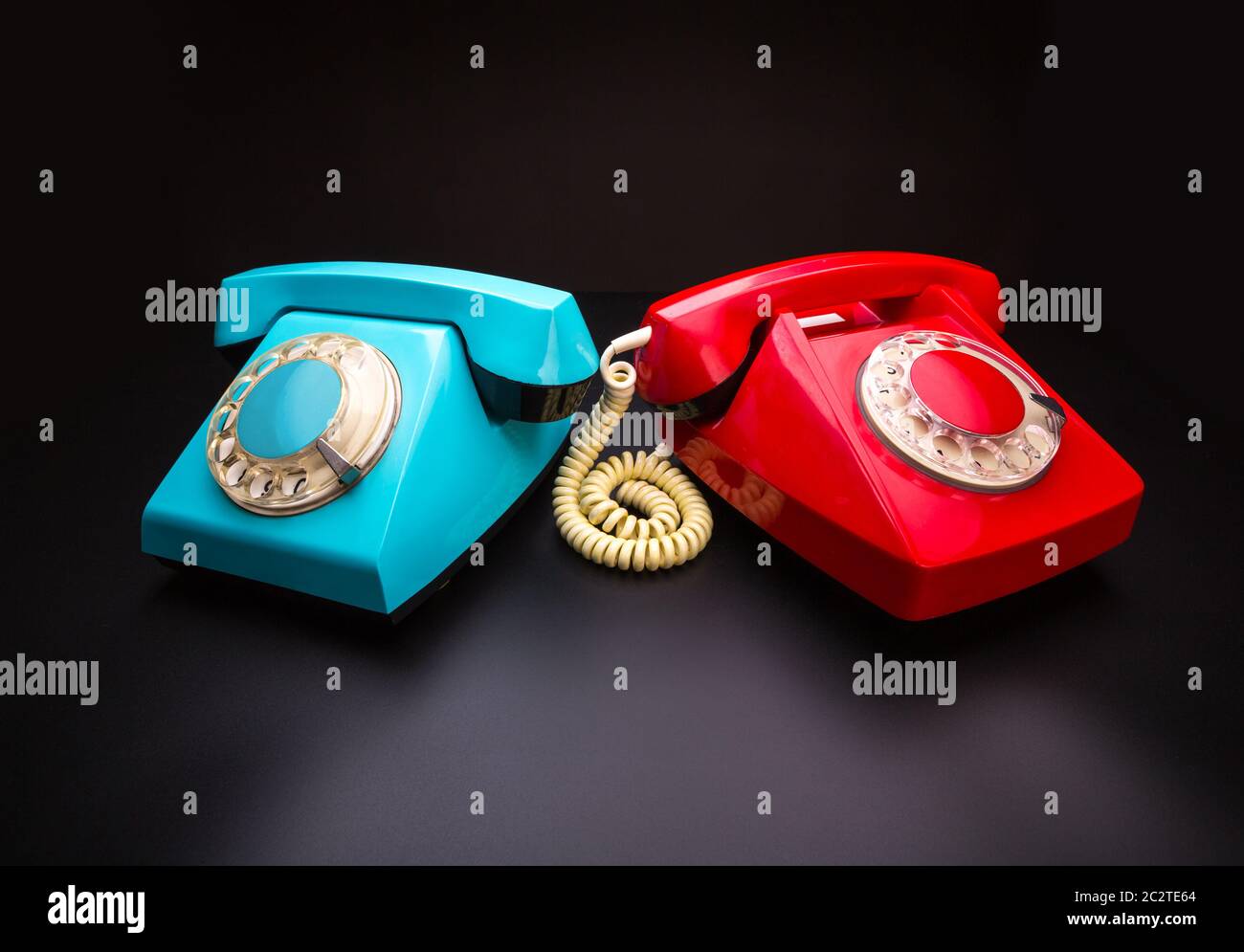 Vintage red and blue telephones side by side Stock Photo - Alamy