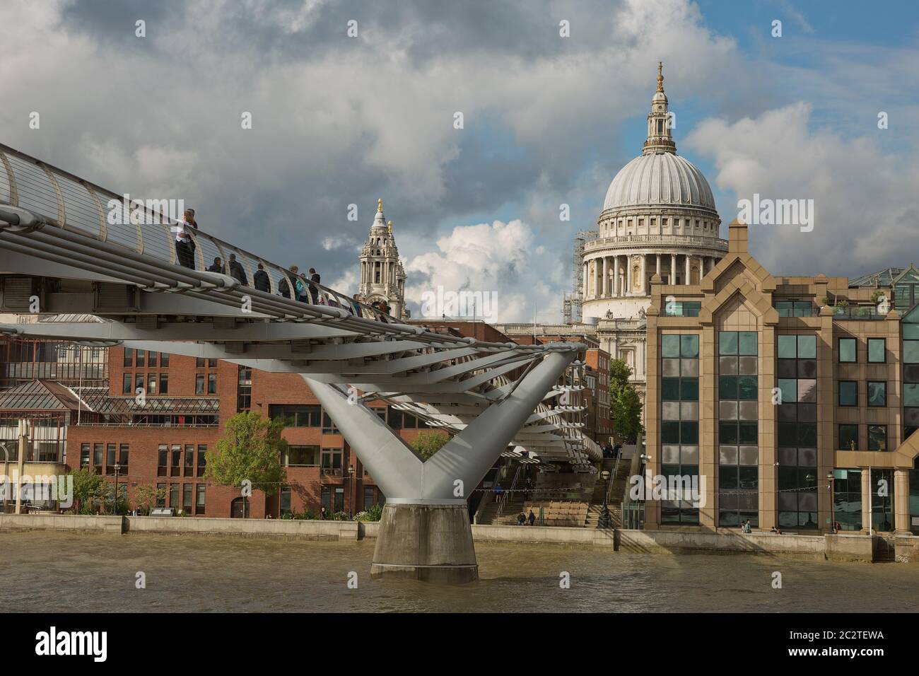 St Pauls Cathedral and the Millennium Bridge in London, United Kingdom during a cloudy day Stock Photo