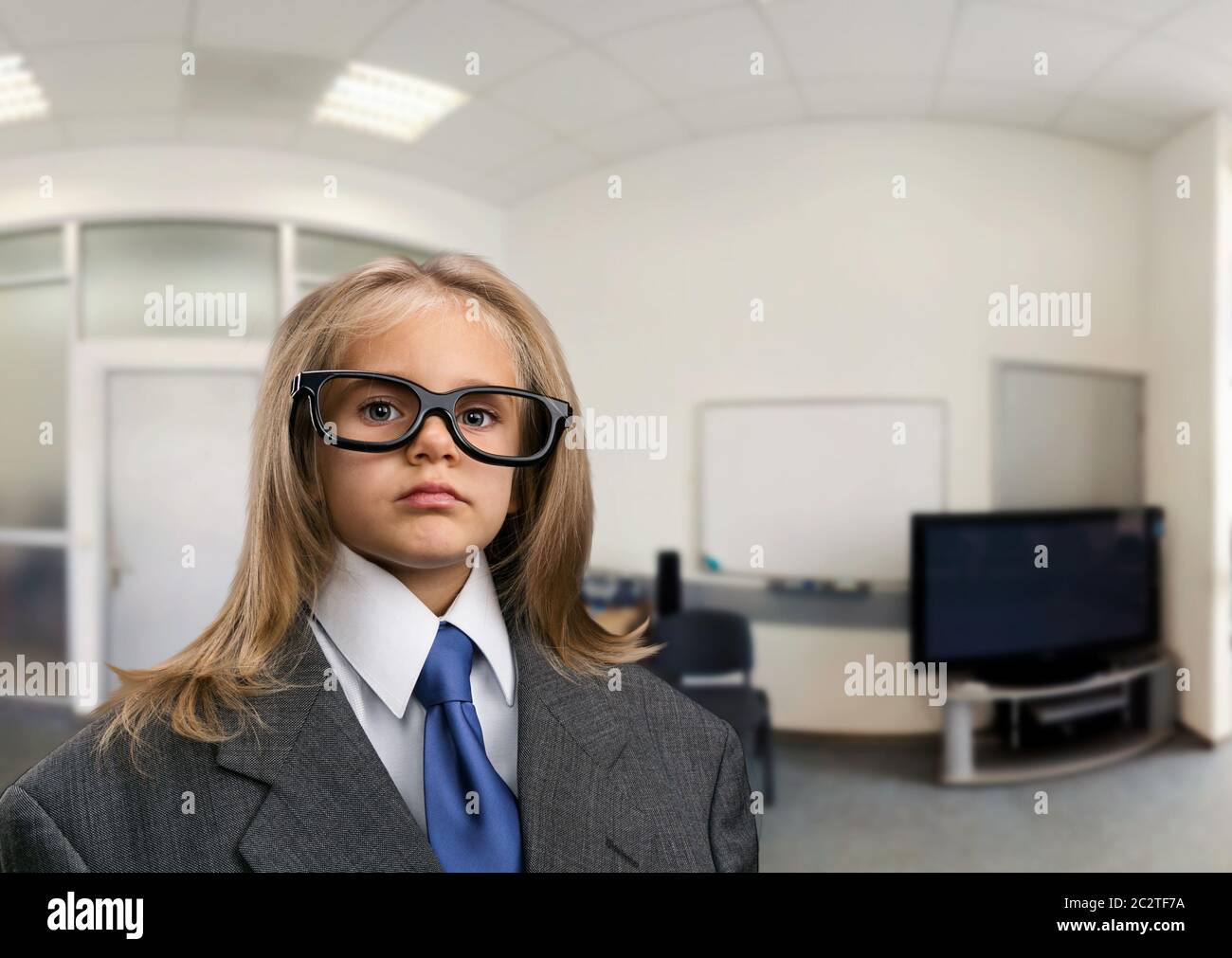 Little serious girl in the office in funny spectacles Stock Photo Alamy