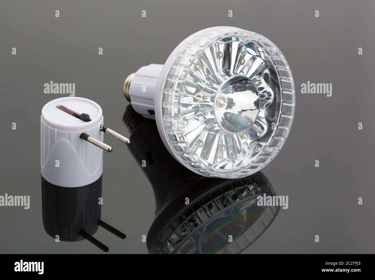 White modern flashlight with two-pin plug on the table Stock Photo