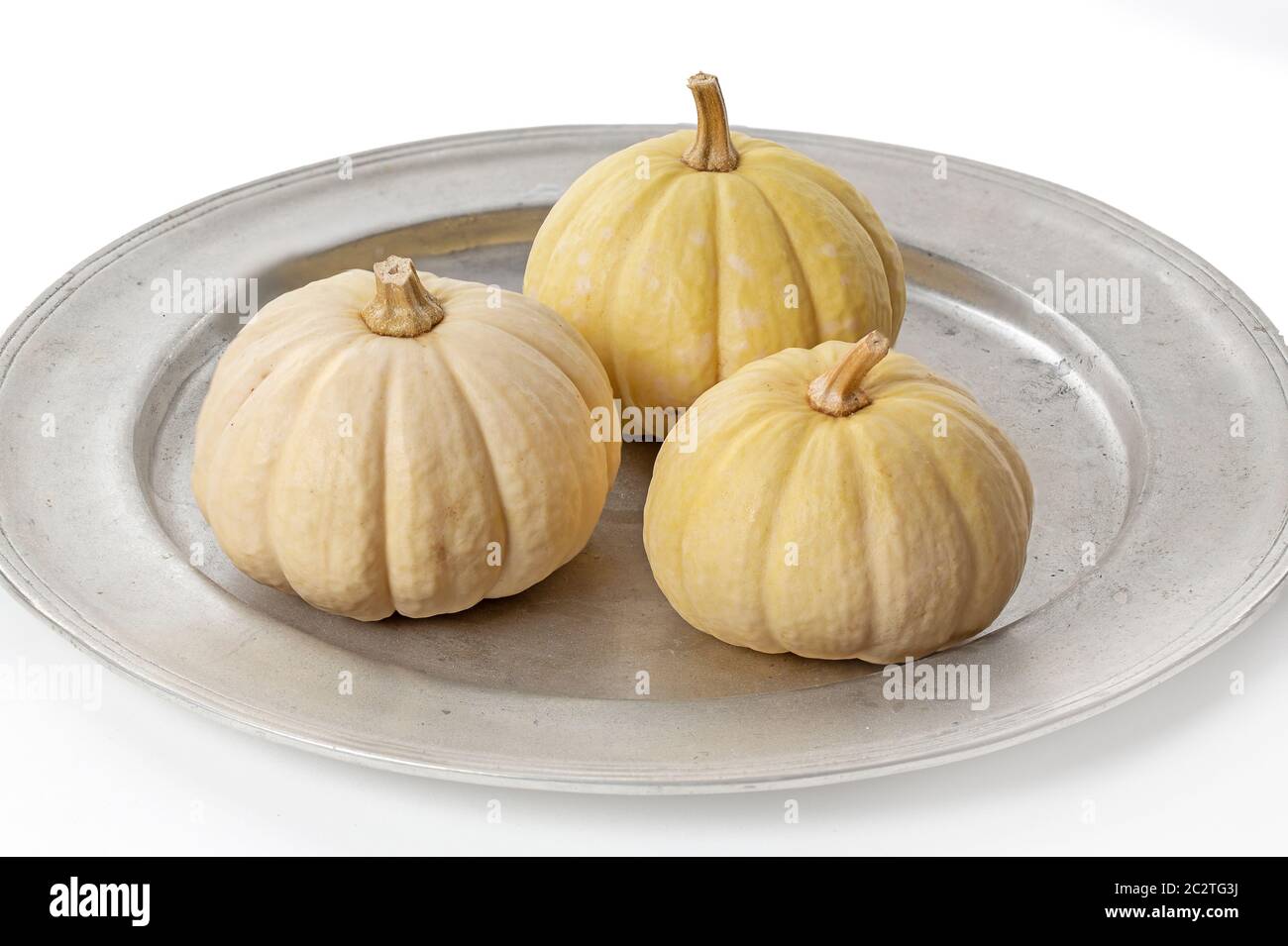 Decorative pumpkins on a tin plate isolated on white background Stock ...