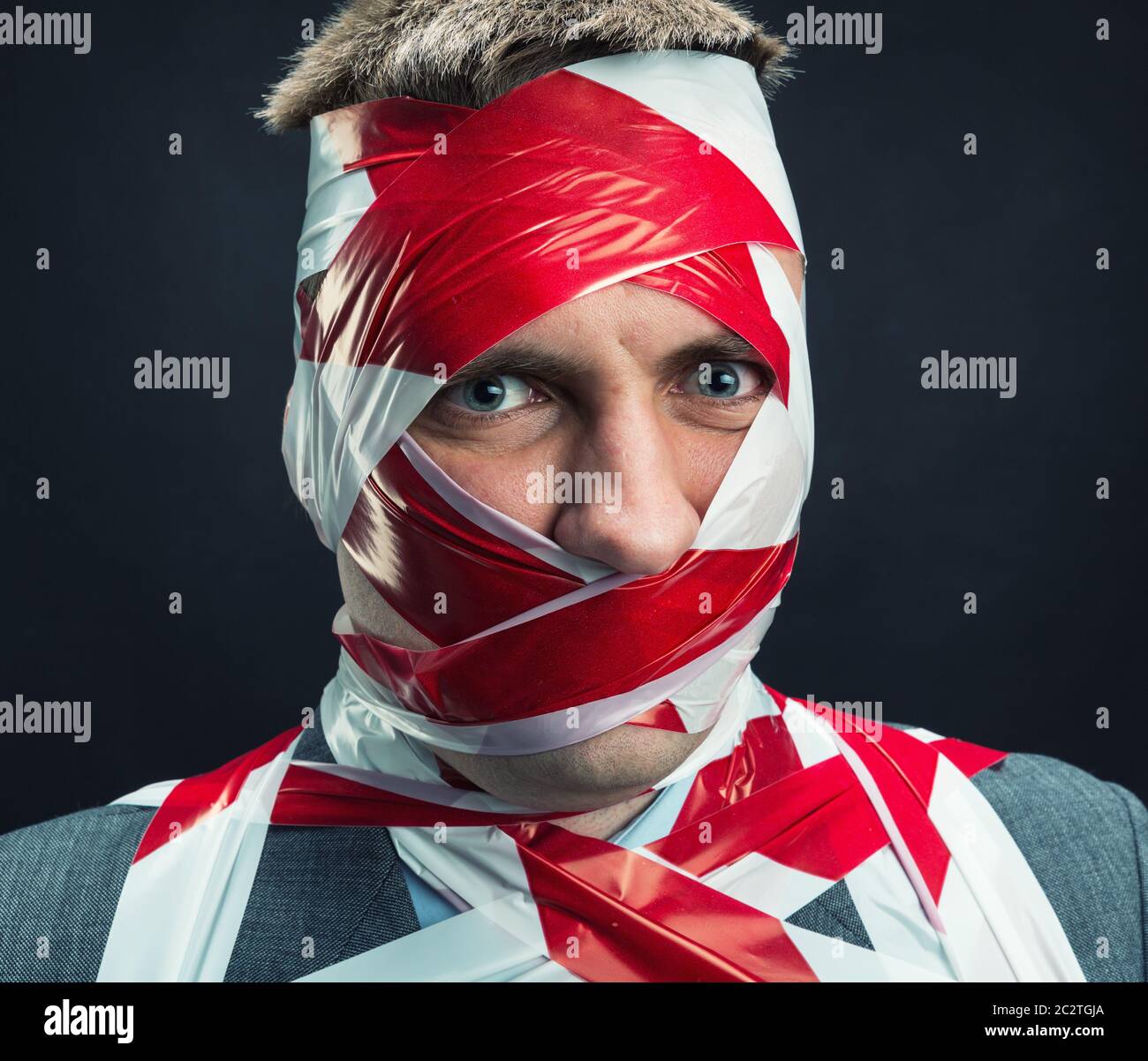 Victum man with stripped duct tape over body Stock Photo
