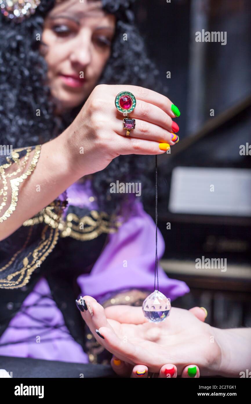 Somebody Using Magic Sorceress reading somebody's hand using magic crystal Stock Photo - Alamy