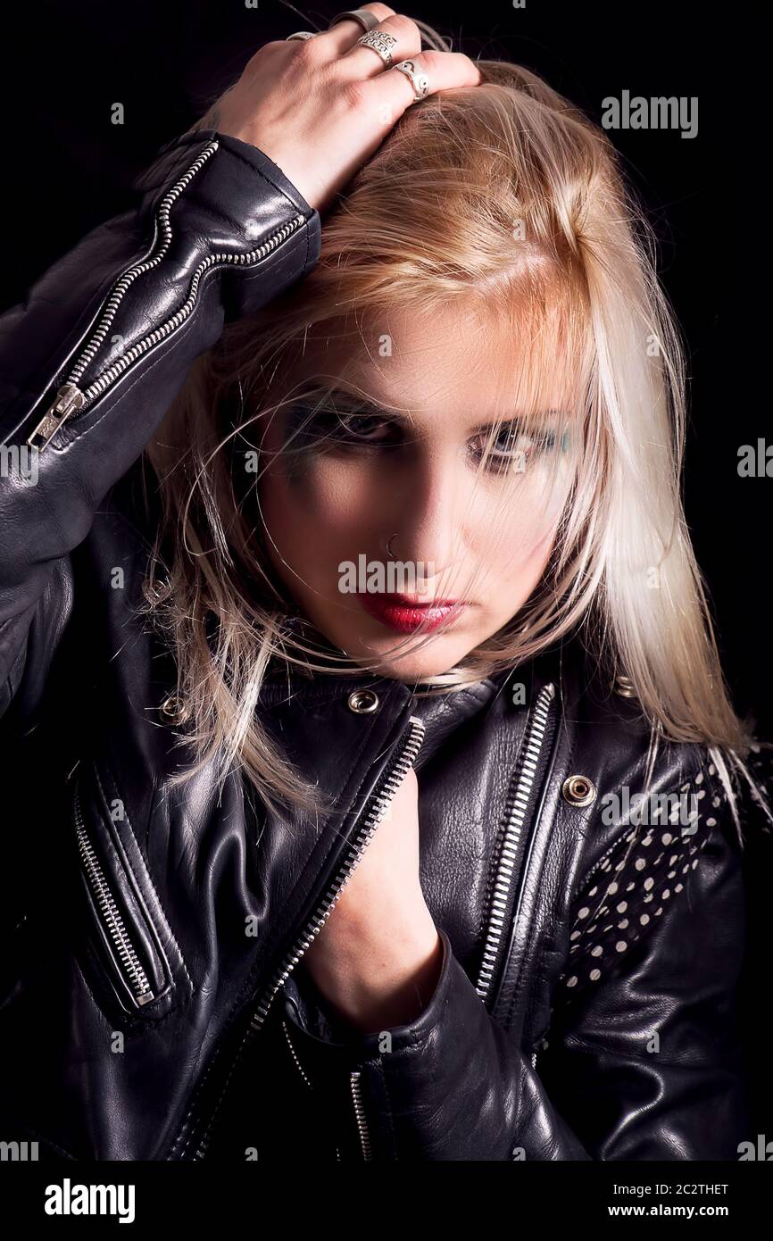 Young blonde woman in a black leather jacket Stock Photo