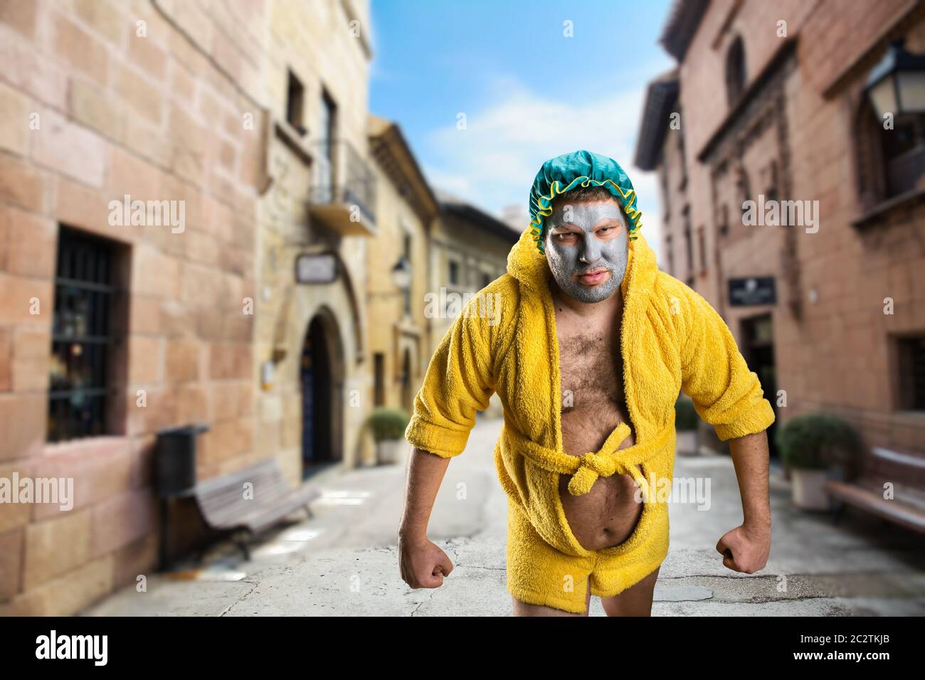 Strange, crazy man with face pack walking in the street Stock Photo