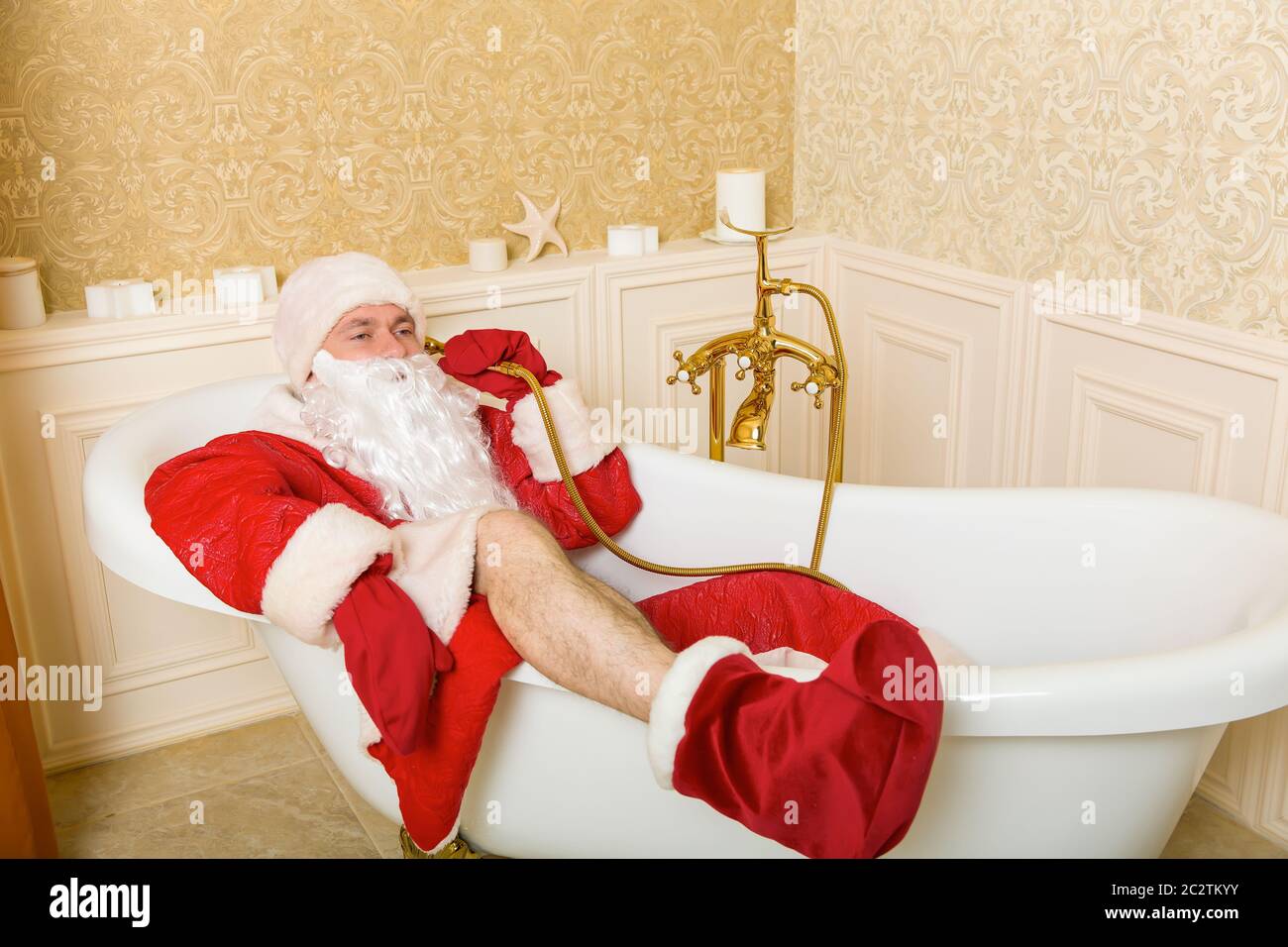 Funny drunk Father Christmas lies in a bath and talking by shower Stock Photo Alamy
