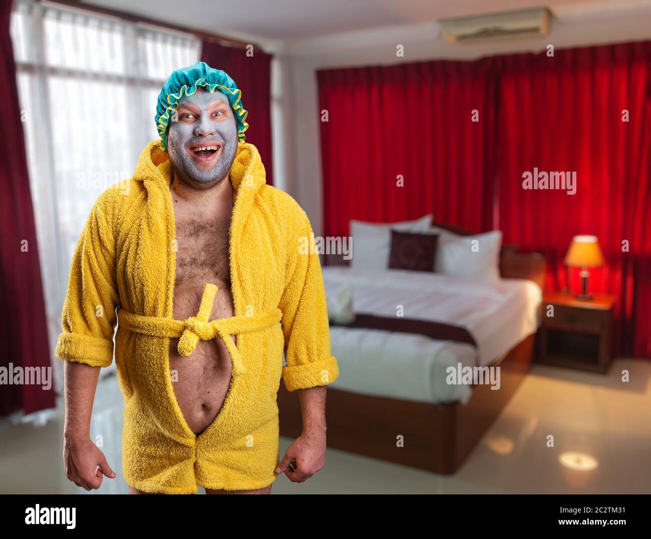 Crazy man with face pack standing in the room Stock Photo