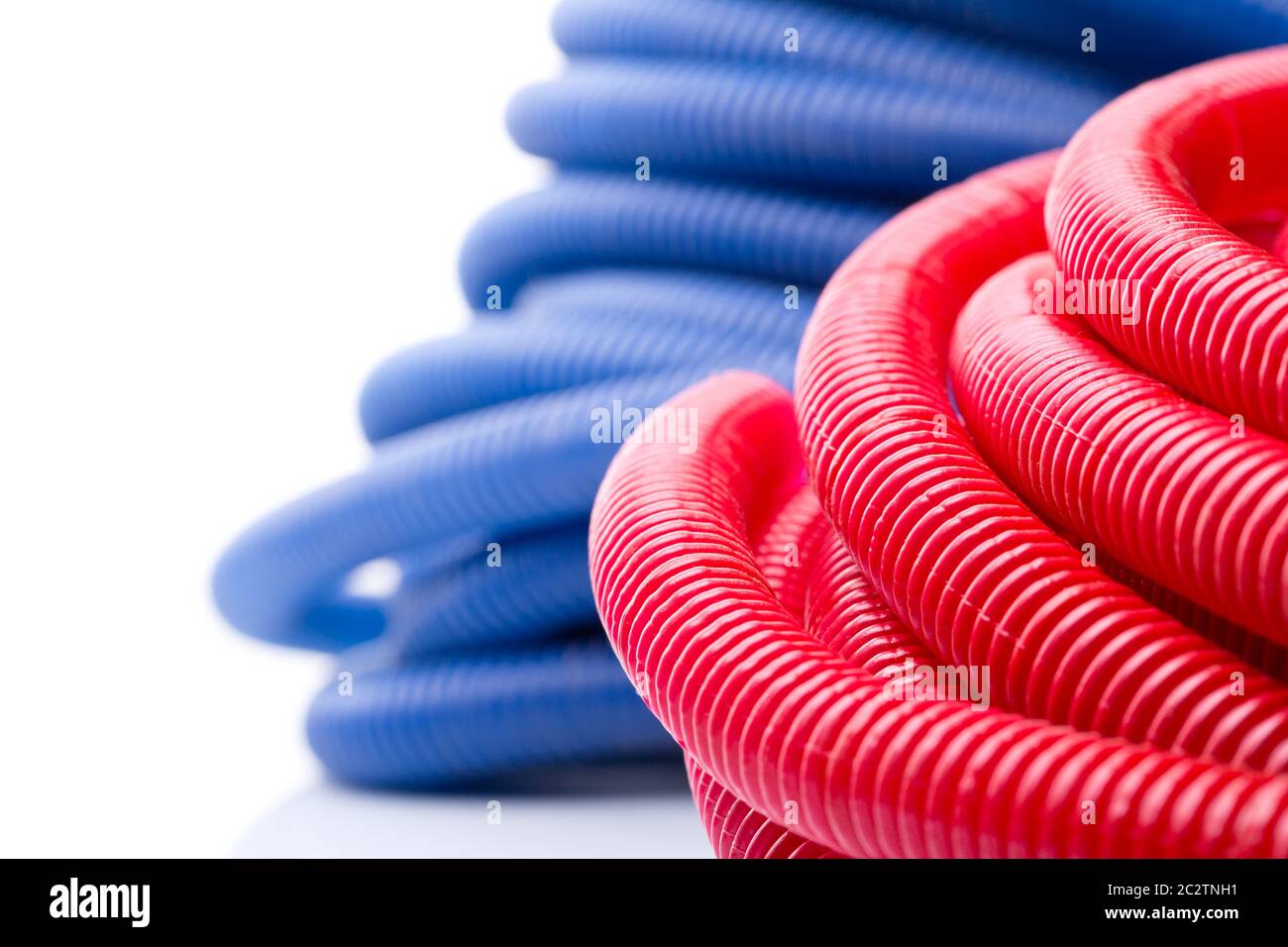 Rolls of red and blue water pipes Stock Photo Alamy