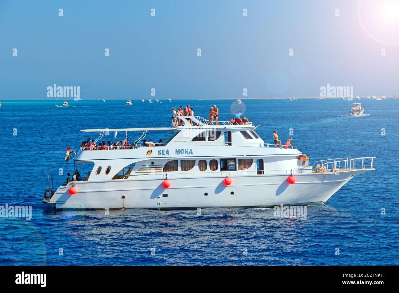Cruise liner with tourists sailing on Red Sea. Sea voyage on white boat. Cruise ship with tourists o Stock Photo