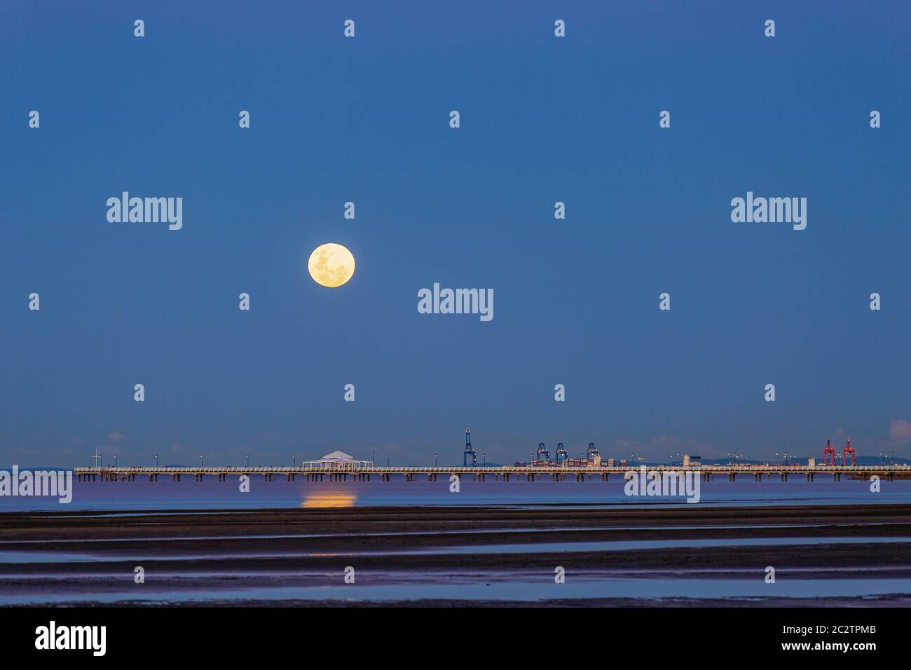 Full moon over Shorncliffe jetty Brisbane Australia with Port of