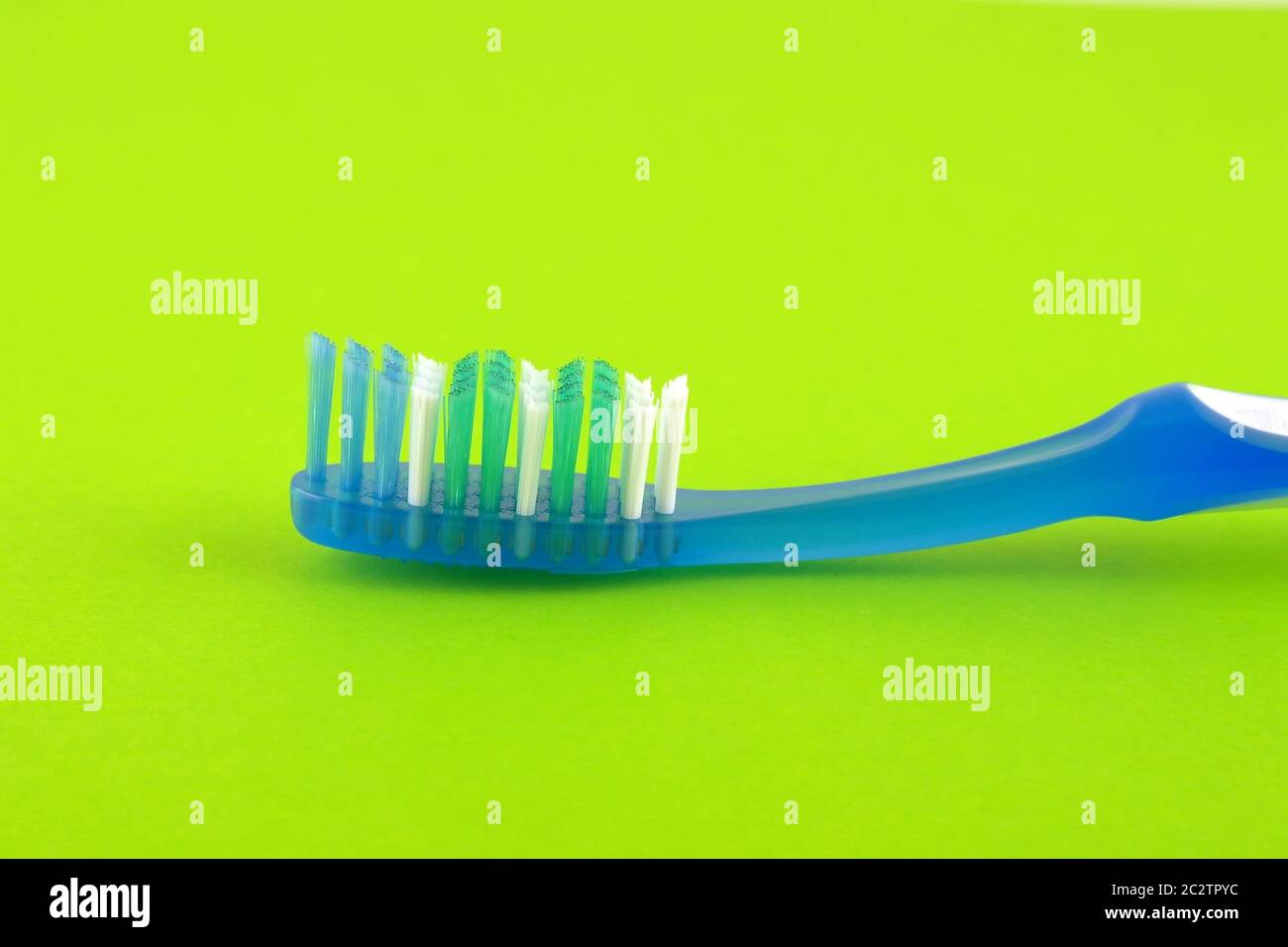 Toothbrush over bright green Stock Photo Alamy