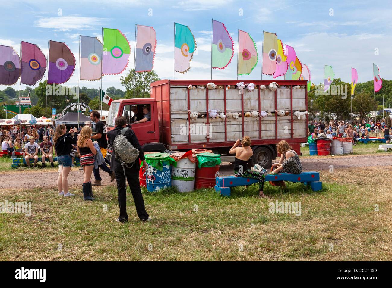 GLASTONBURY, UK - JUNE 26, 2014:  People looking at the travelling art installation at Glastonbury Festival by British Graffiti artist Banksy called ' Stock Photo