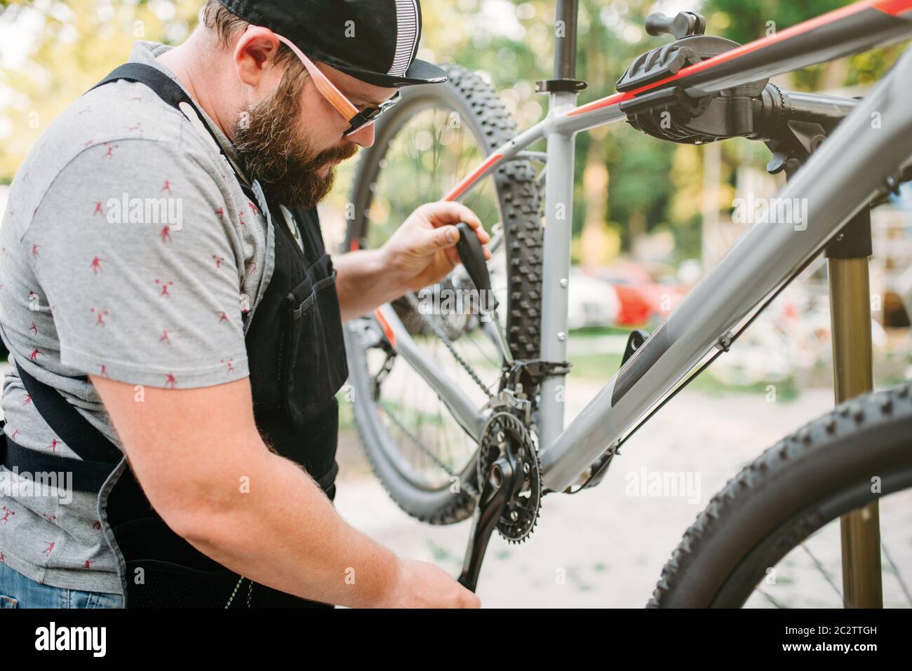 Bicycle mechanic repair front speed shifter. Cycle outdoor