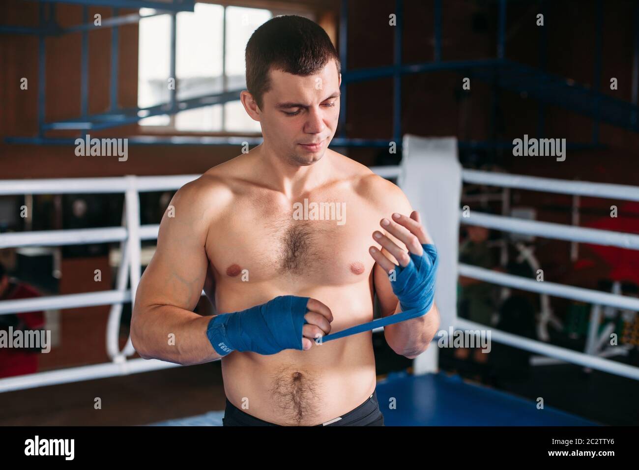 Close-up Of Hand Of Strength Boxer Who Pulls Bandage Before The