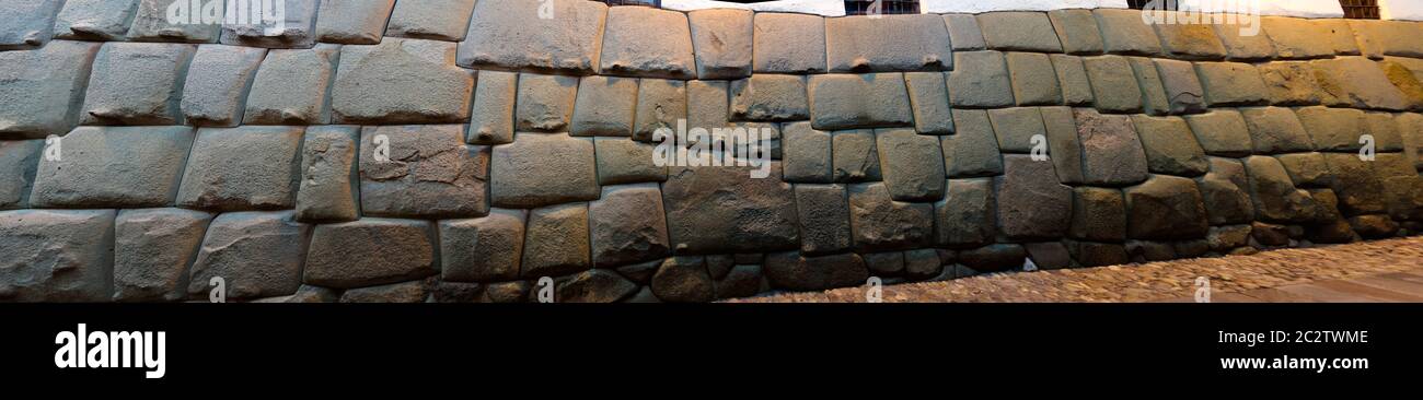 View to Twelve-angled stone aka Hatun Rumiyoc as a part of a wall of the palace of the Archbishop of Cuzco, Peru Stock Photo