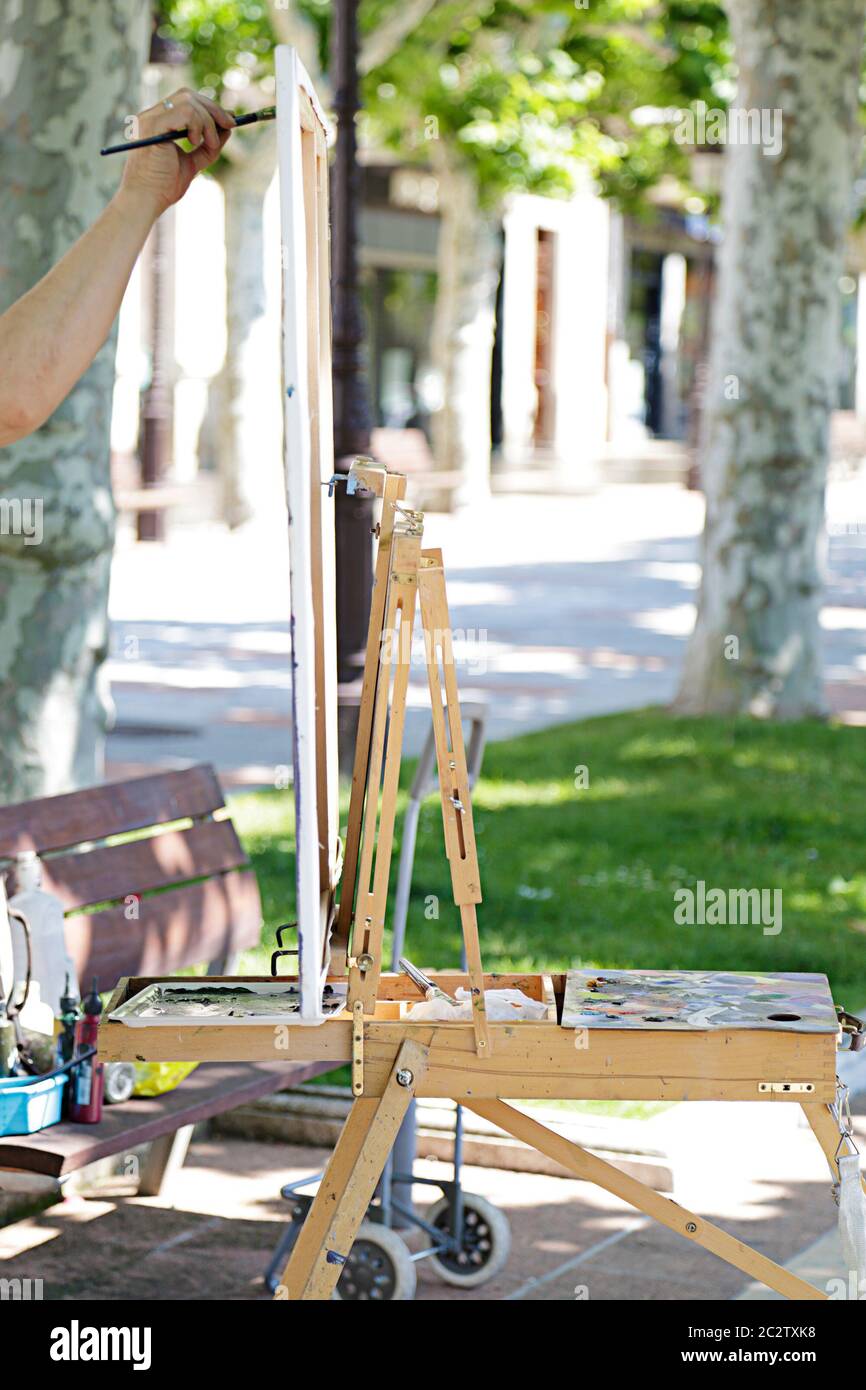 Man artist painting on the street Stock Photo