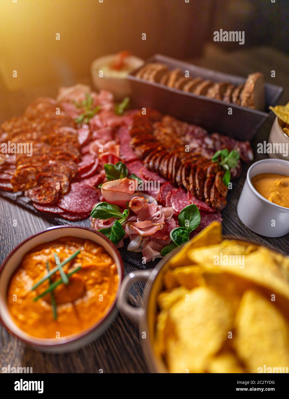Welcome table with appetizers, cold cuts, nachos and dips Stock Photo