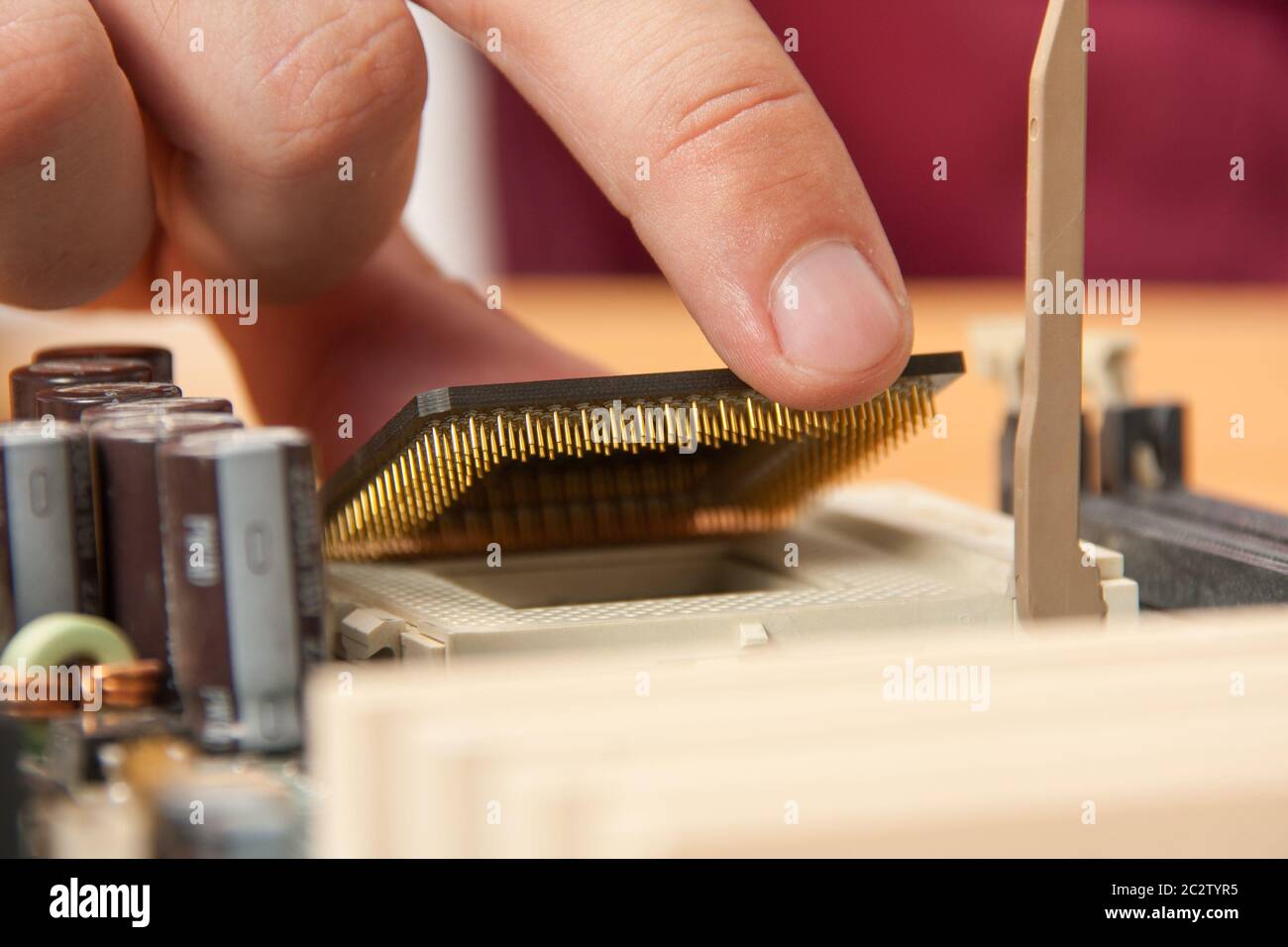 Installing computer processor to motherboard Stock Photo