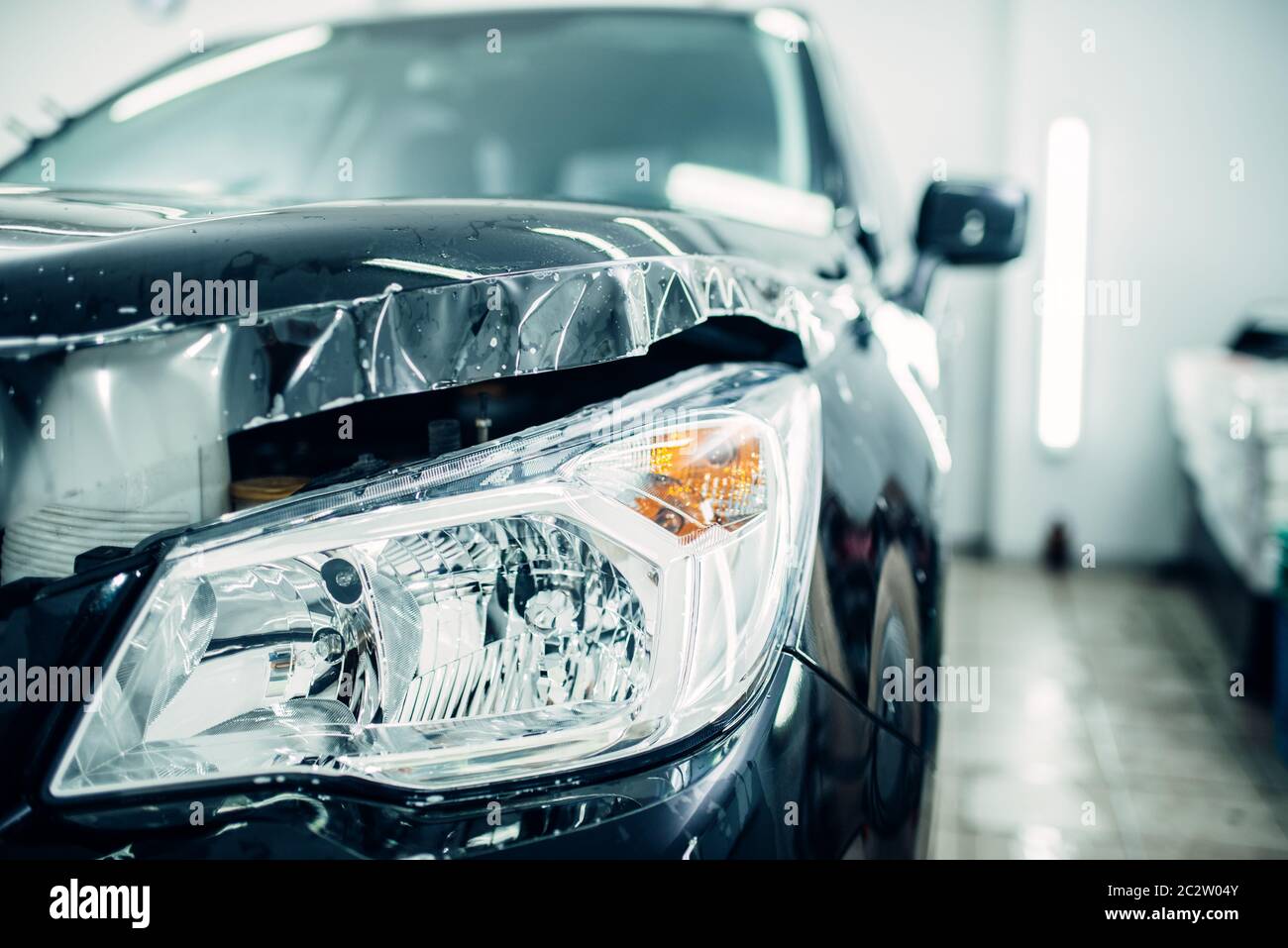 Car hood wraped in paint protection film closeup, protect against chips