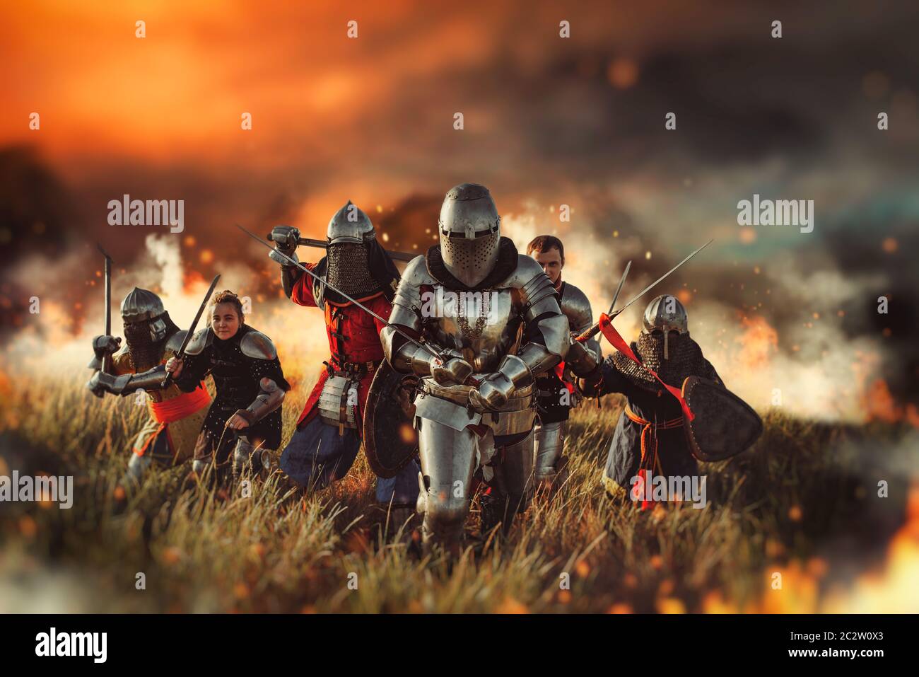 Medieval knights in armor and helmets with swords and axes on battle field,  great combat. Armored ancient warriors Stock Photo - Alamy
