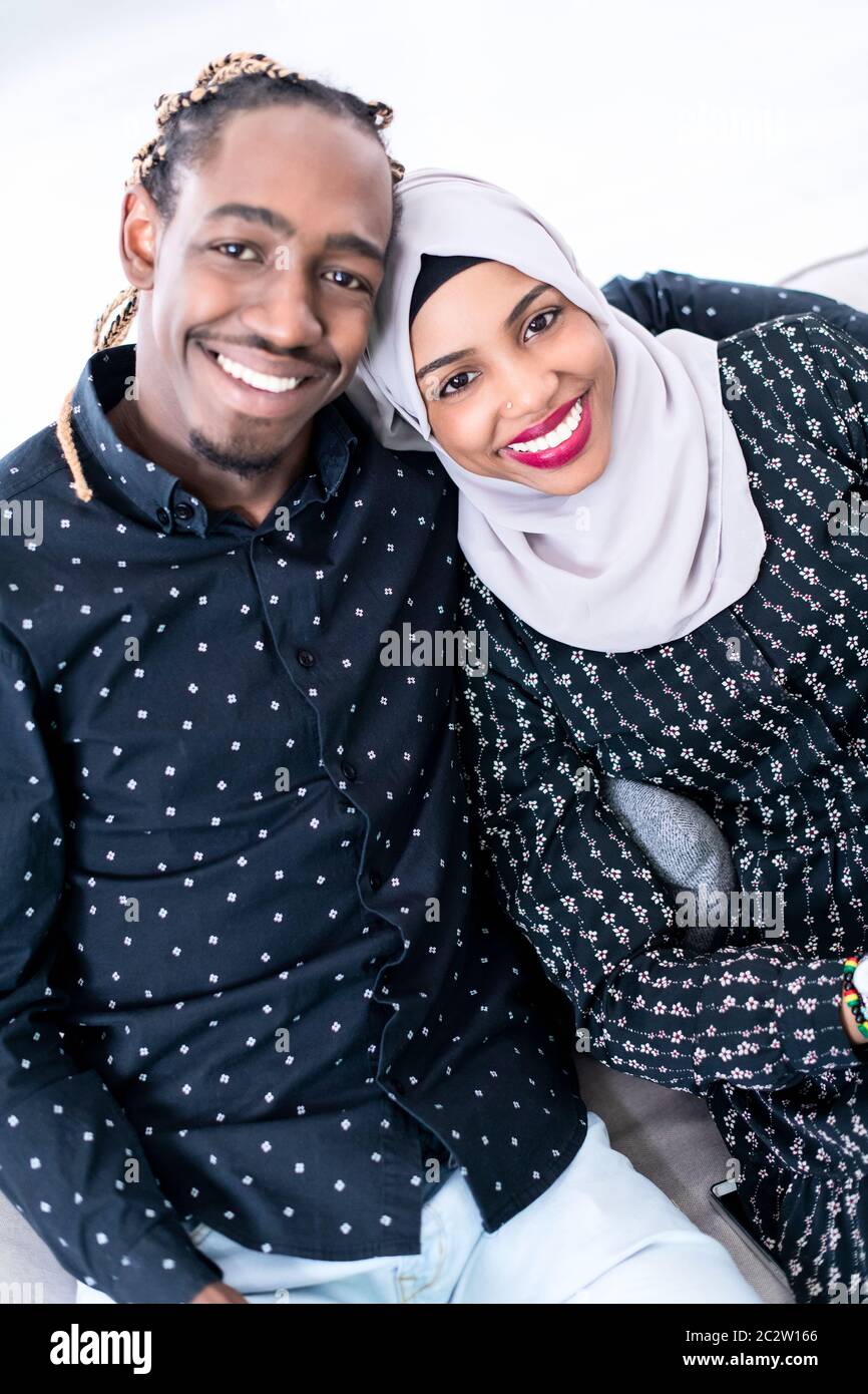 African Couple Sitting On Sofa Watching TV Together Stock Photo - Alamy