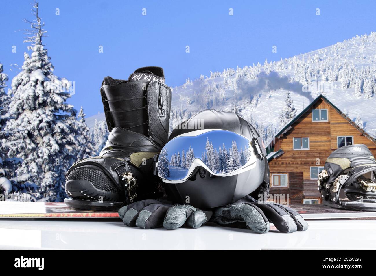 Winter sport glasses, snowboarding boot, helmet and gloves on winter