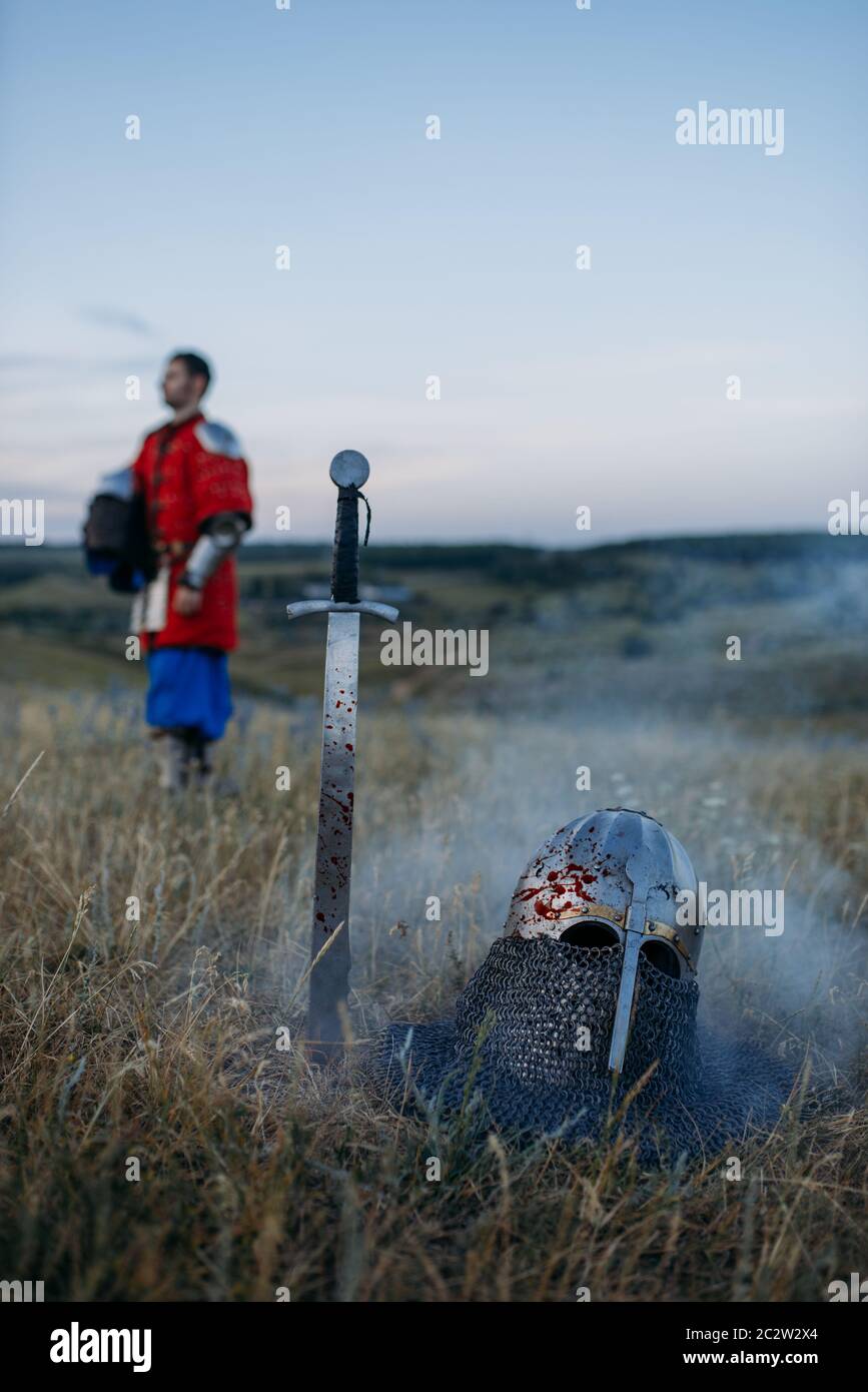 Sword stuck in the ground and metal knight helmet, nobody, great ...