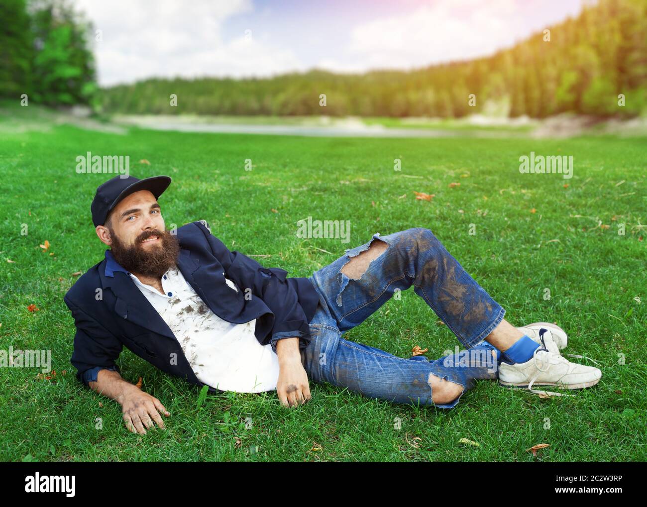 Happy homeless lying on the lawn Stock Photo