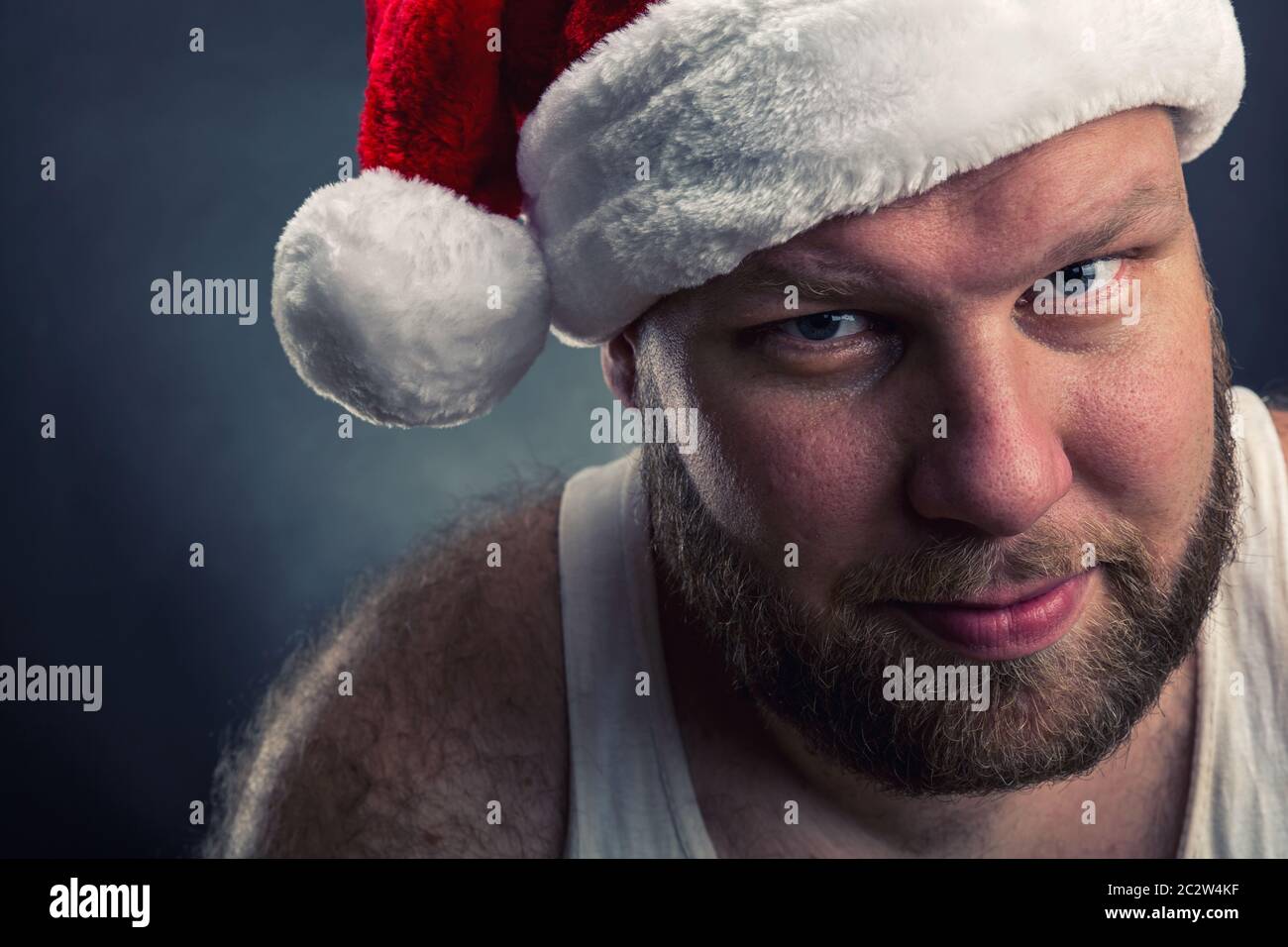 Smiling man in Santa Claus hat closeup Stock Photo