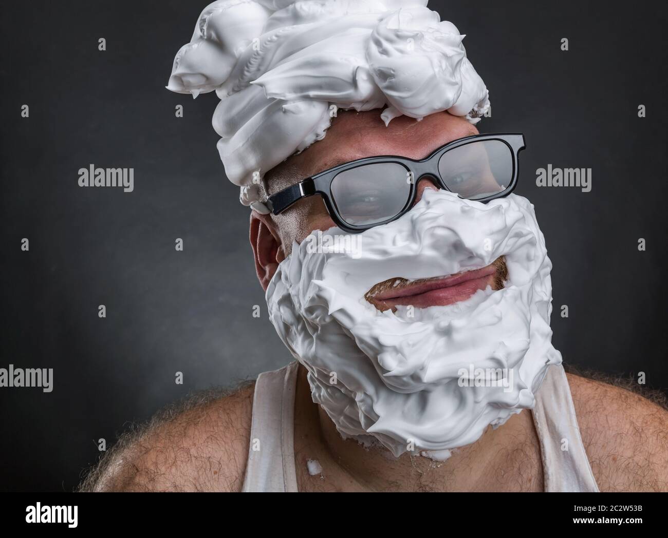 Strange smiling man in glasses with shaving foam on his face and on his  head closeup Stock Photo - Alamy