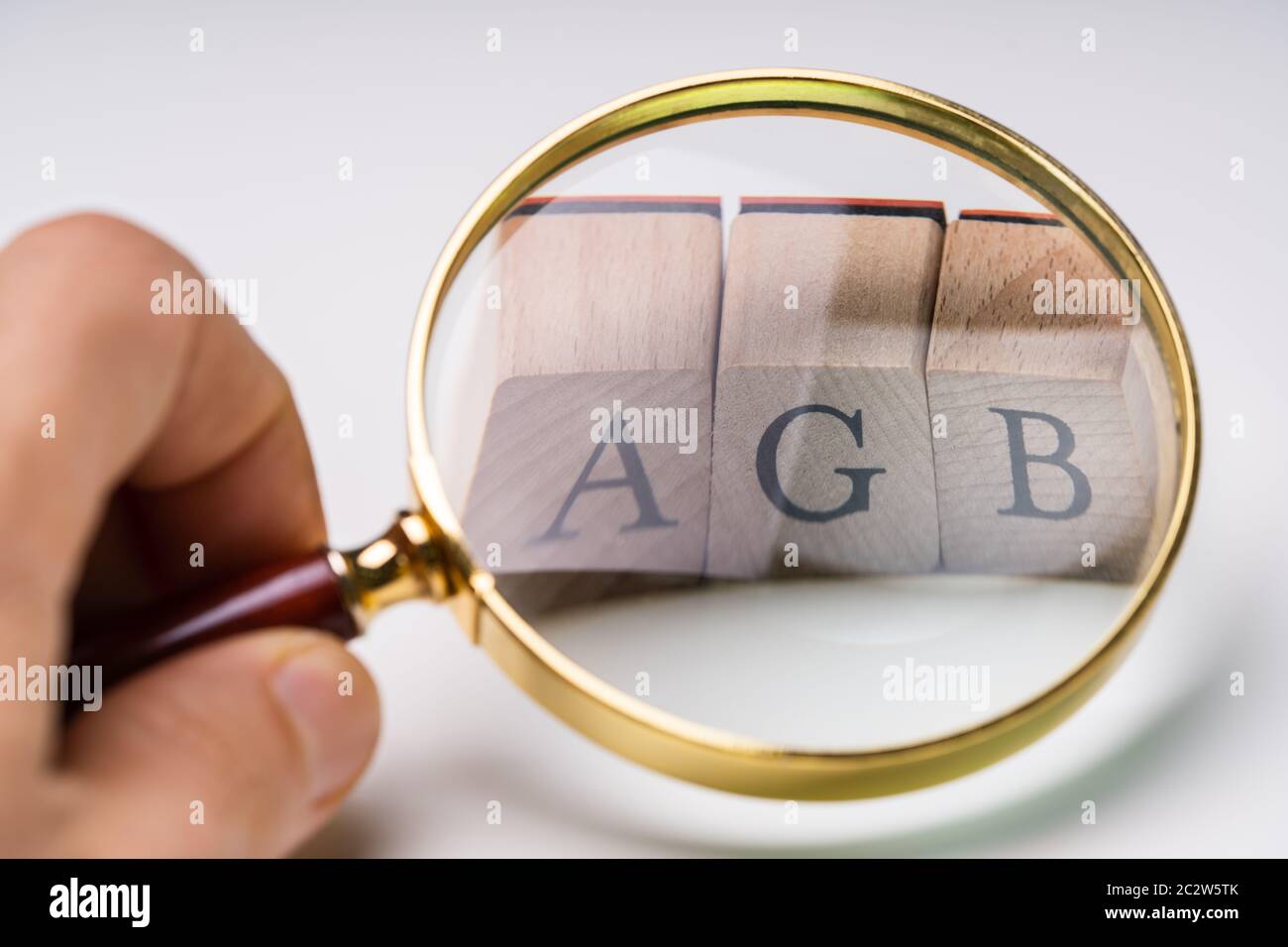 Closeup Of AGB Letters  Under Magnifying Glass. Standard Form Contract In Germany Stock Photo