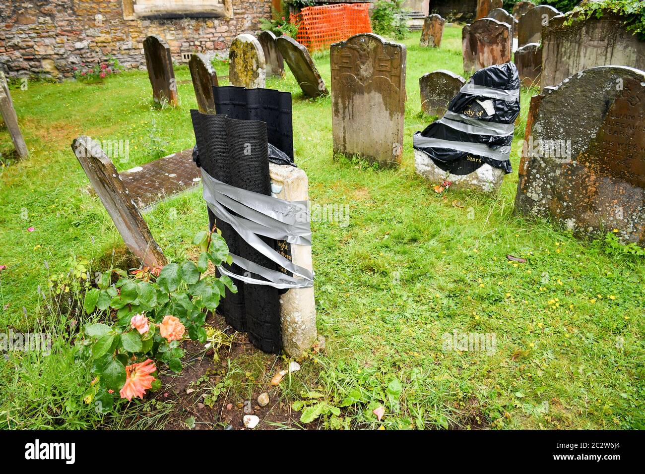 The grave of an enslaved African man in St Mary's churchyard in Henbury, Bristol, which has been vandalised in an apparent 'retaliation attack' following the toppling of a statue of slave trader Edward Colston in Bristol. Two headstones on the Grade II-listed, brightly painted memorial to Scipio Africanus have been smashed and a message was scrawled in chalk on flagstones nearby. Stock Photo