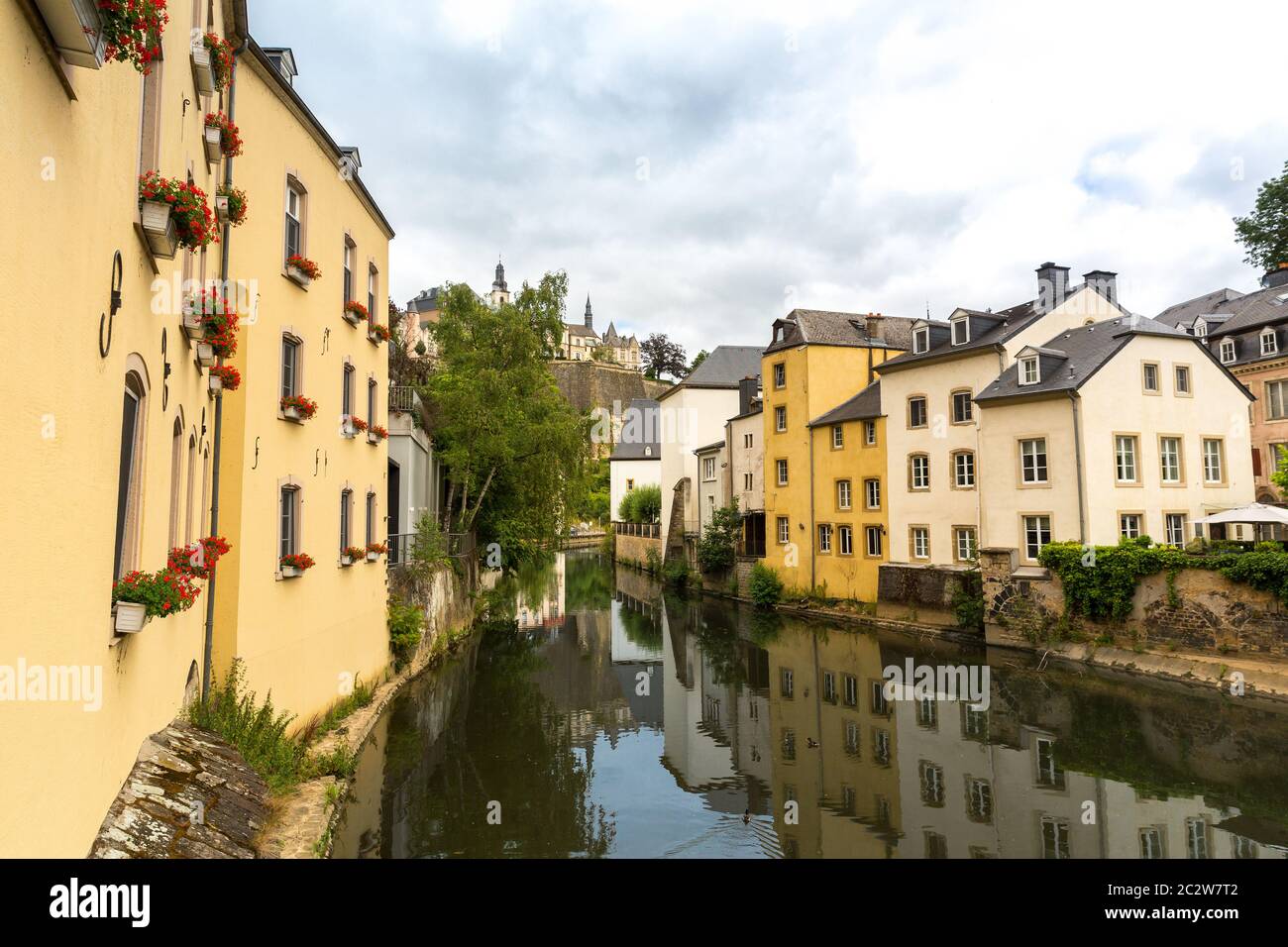 Building facades on river canal in old tourist town on background ...