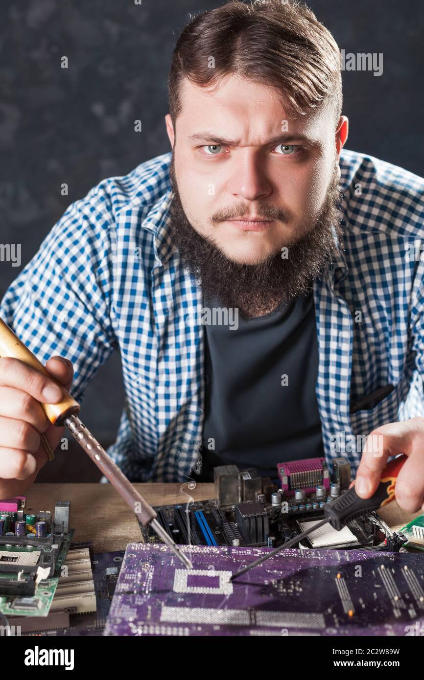 Worker soldering electronic components hi-res stock photography and ...