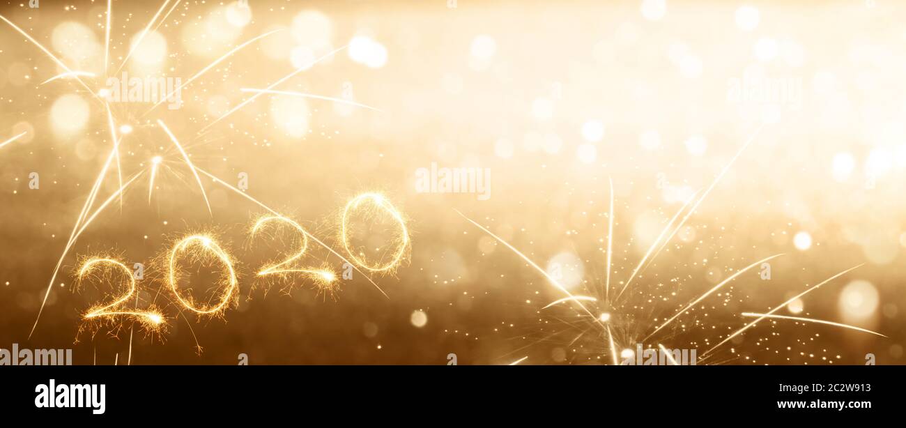 Sparkling new years eve 2020 for a golden background concept Stock Photo
