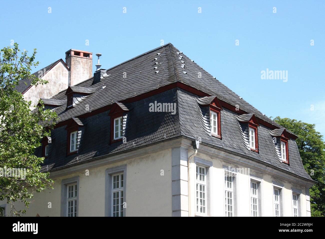 A slate roof with Windows and dormers Stock Photo